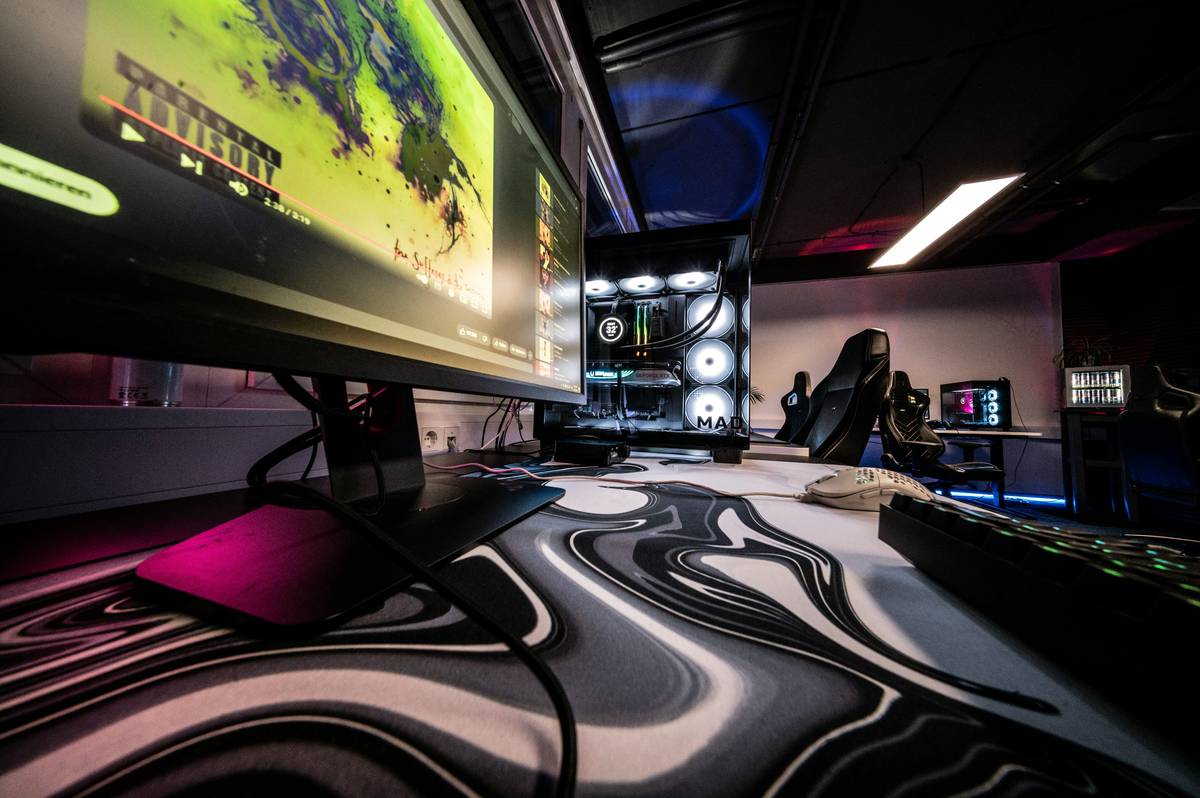 gaming room ideas with bed featuring a loft bed setup with desk underneath and ambient LED lighting